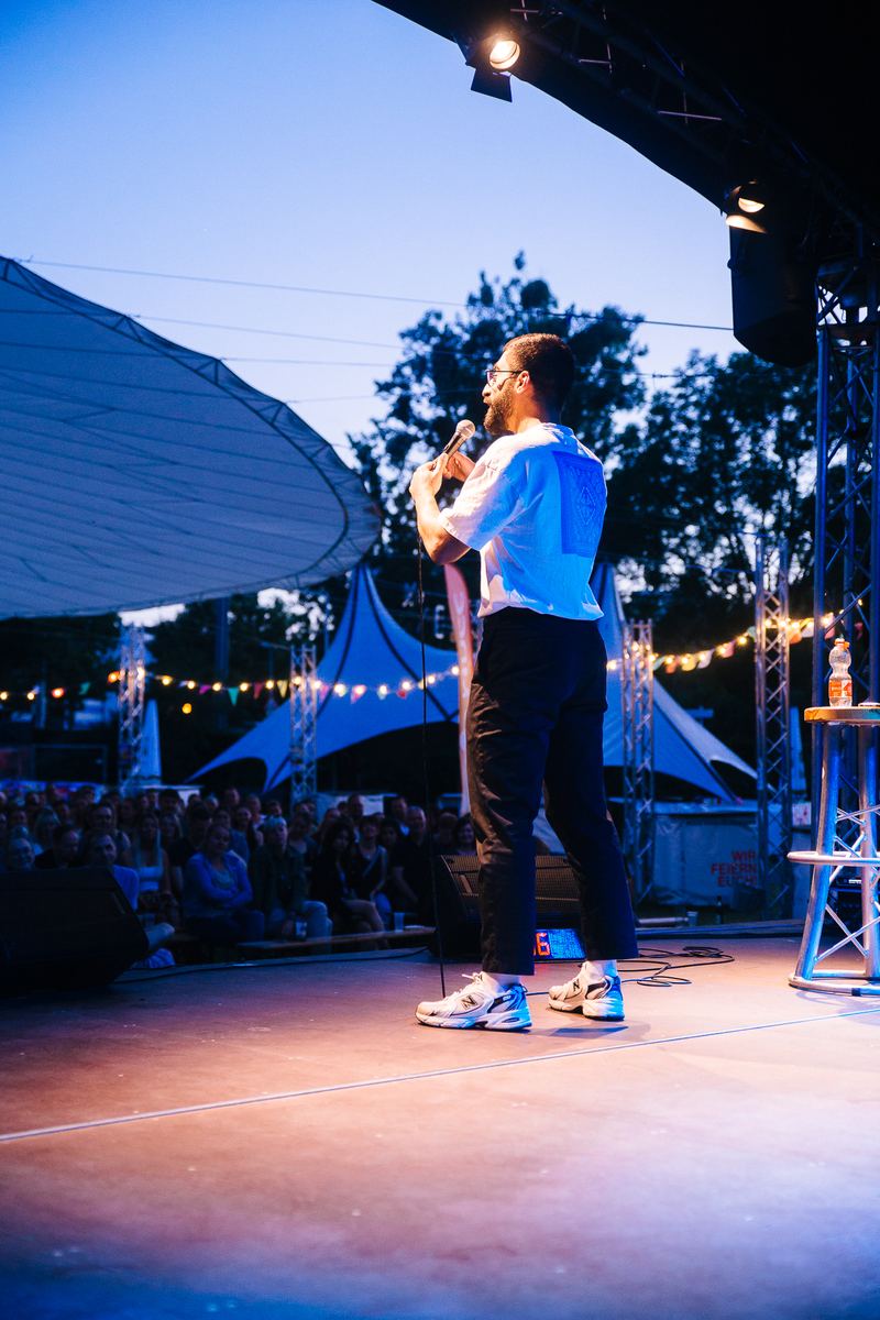 Comedian im Abendlicht auf Freiluftbühne